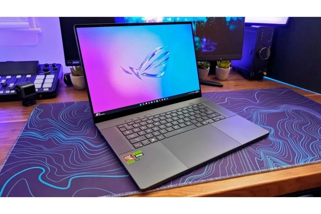 The powerful Asus ROG Zephyrus G16 gaming laptop open on a desk with a colorful screen, popular among those seeking the Best Student Laptops for both gaming and coursework.