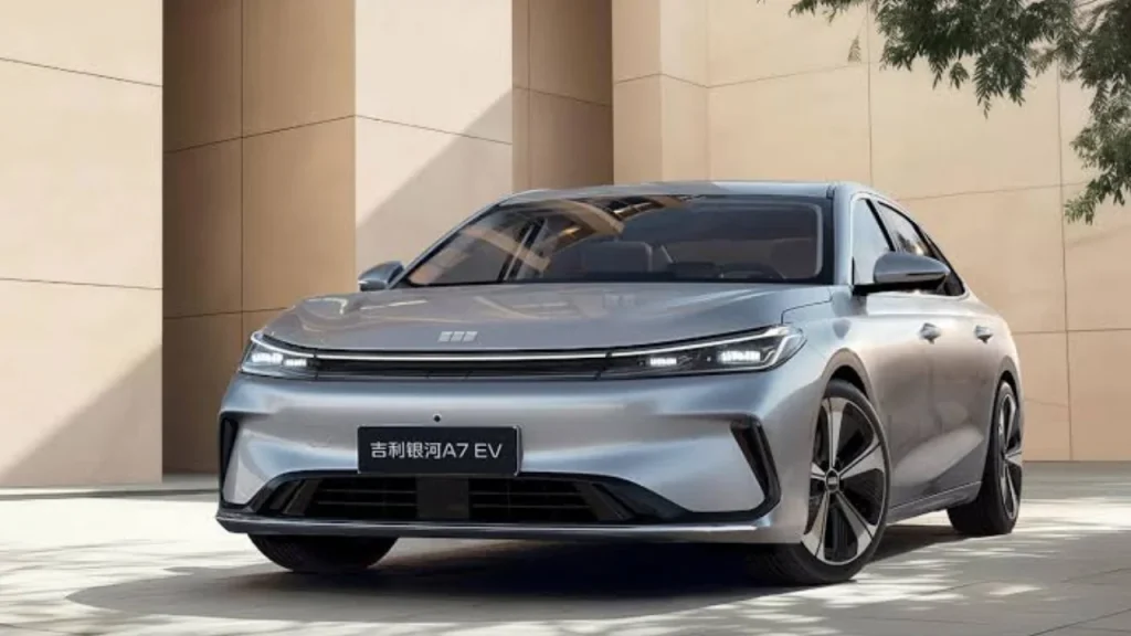 A sleek silver Geely electric sedan parked outdoors against a modern architectural background, representing excellence among the Best EV brands.