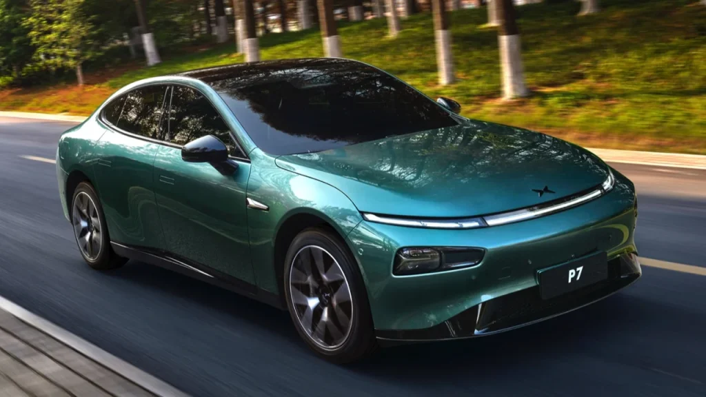 A green XPeng electric sedan driving smoothly along a tree-lined asphalt road, highlighting performance from the Best EV brands.